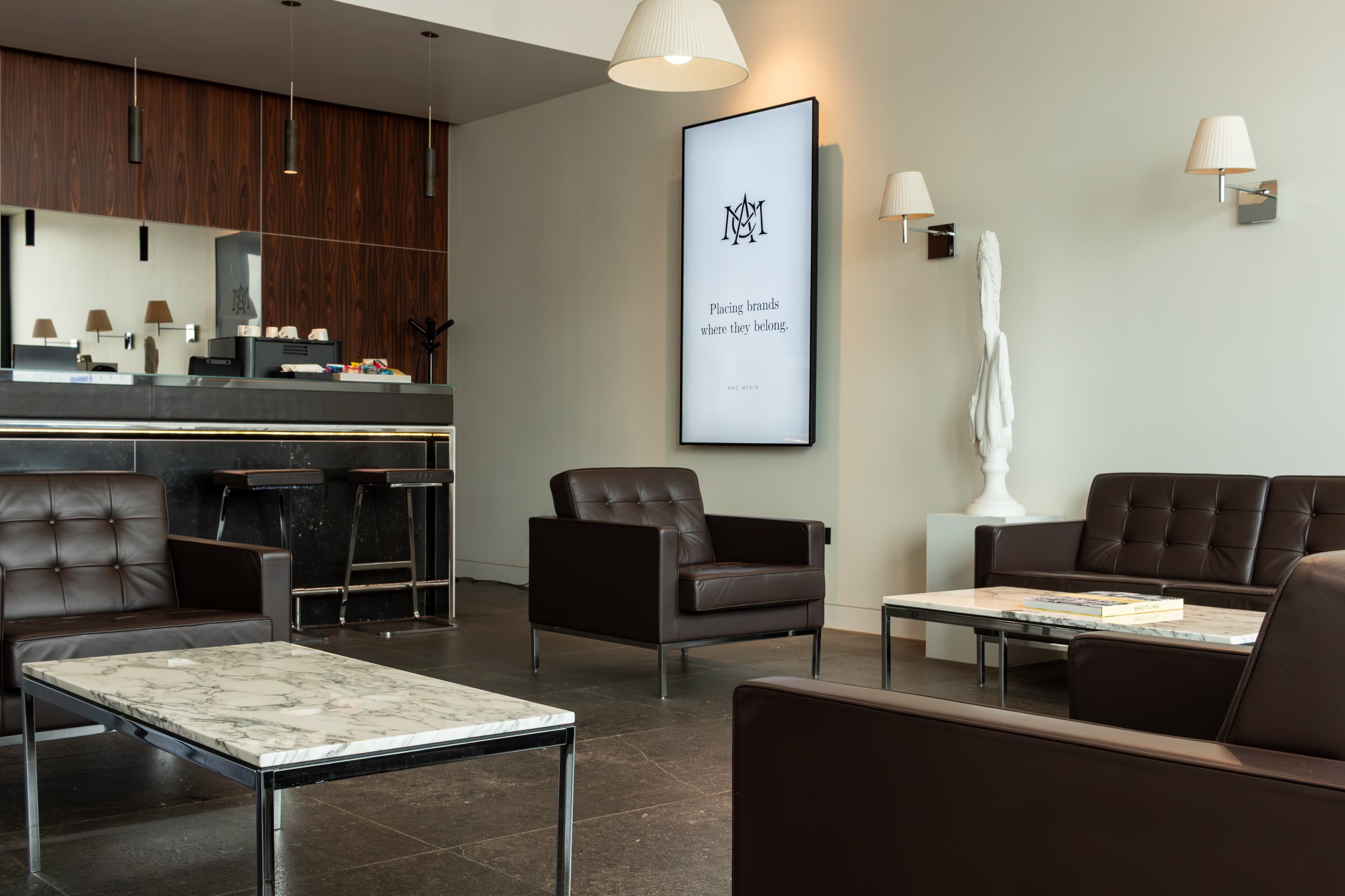 Digital display mounted in a private aviation lounge seating area