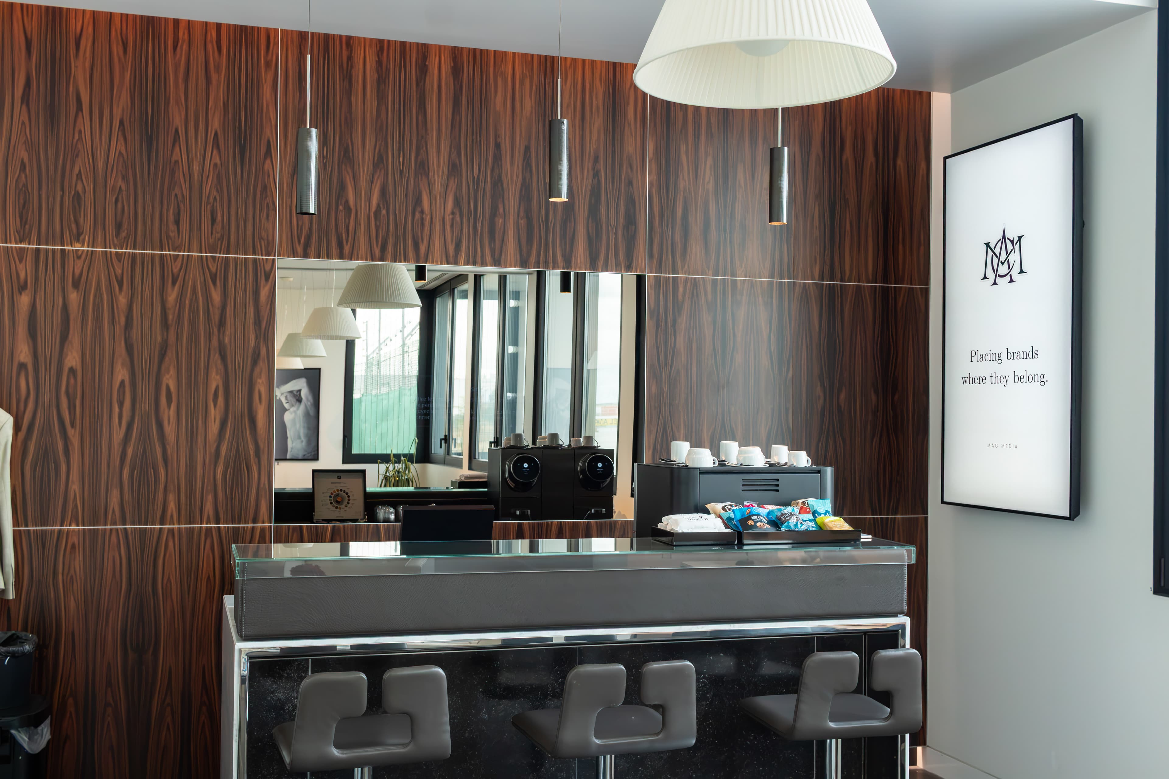 Digital display above the refreshment bar of a private aviation lounge